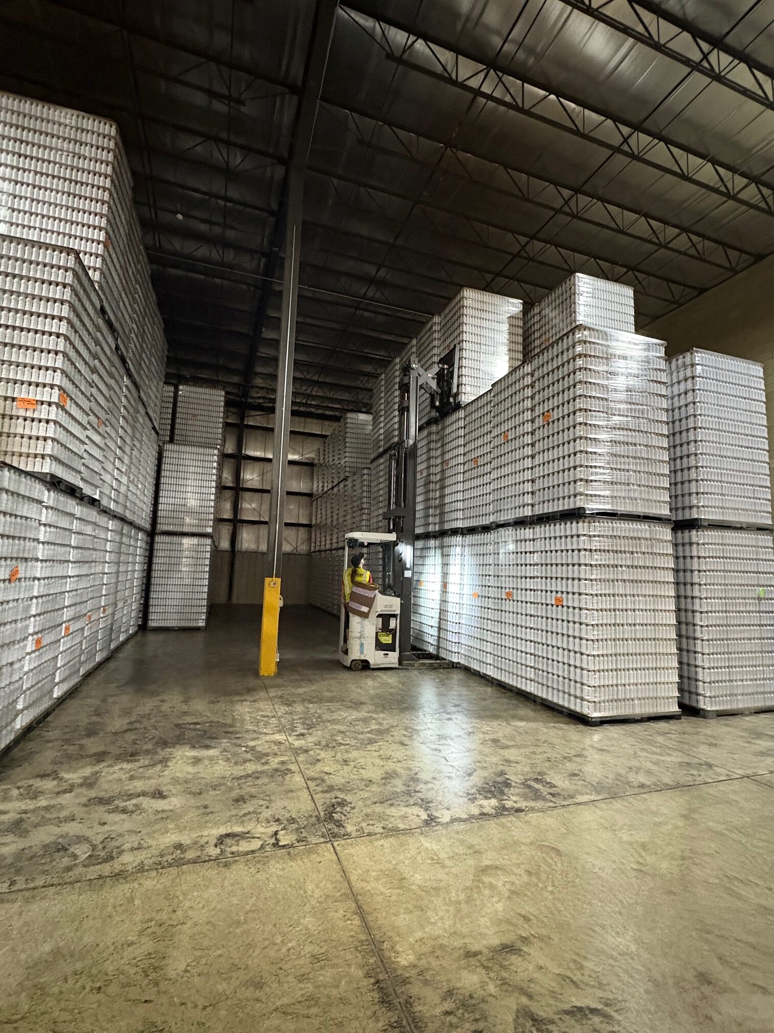 forklift stacking pallets in warehouse