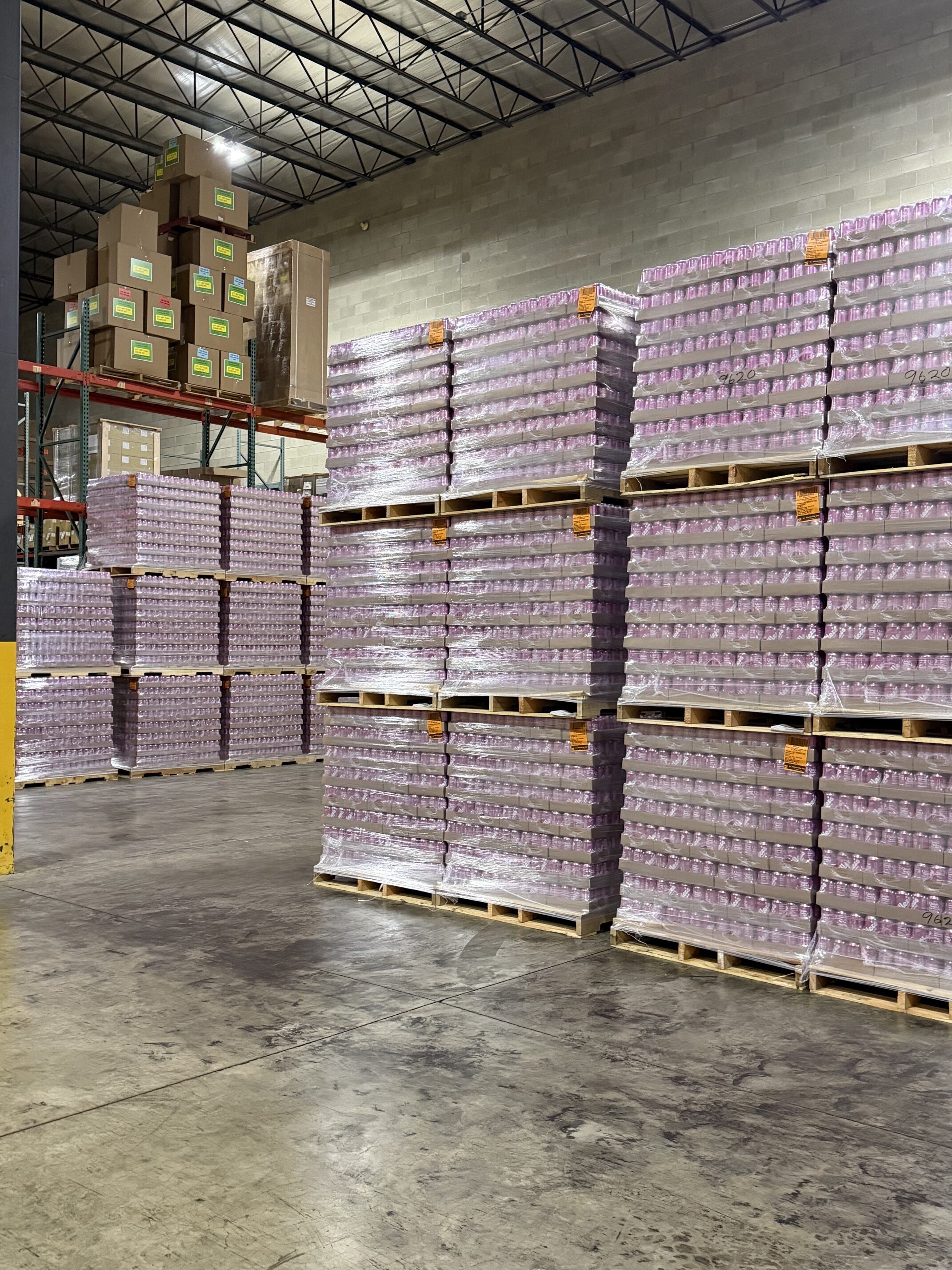 pallets of soda cans in warehouse