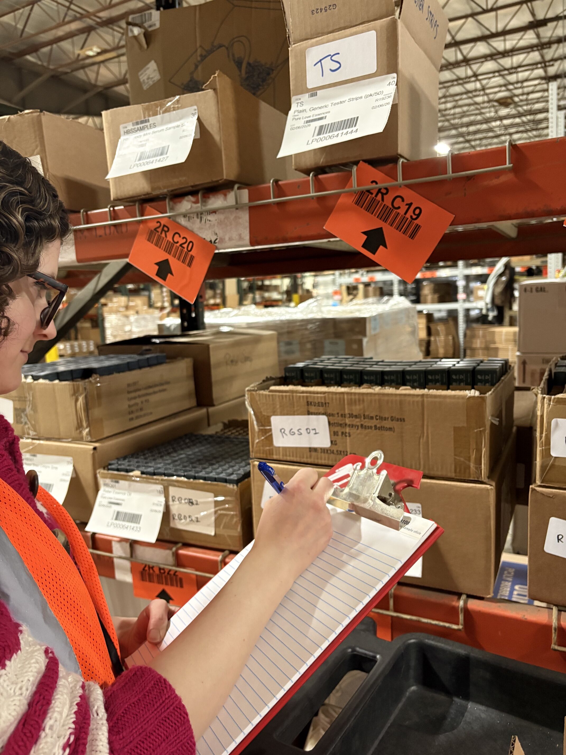 woman taking inventory of retail products in warehouse