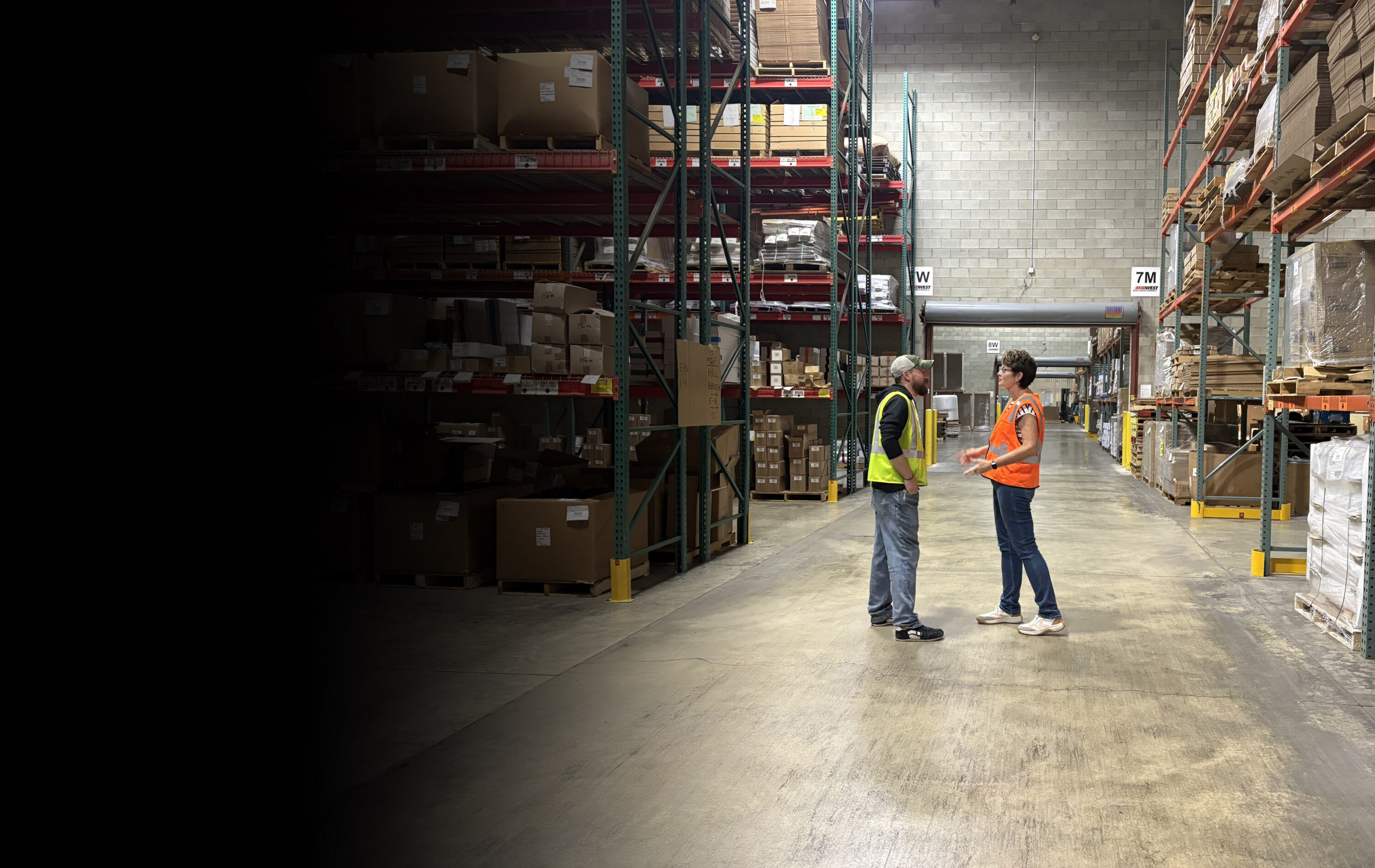 two people talking in warehouse