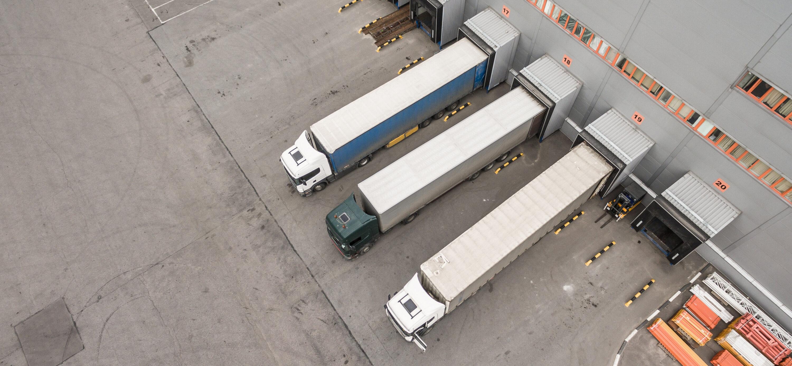 trucks parked at different docks at warehousing facility