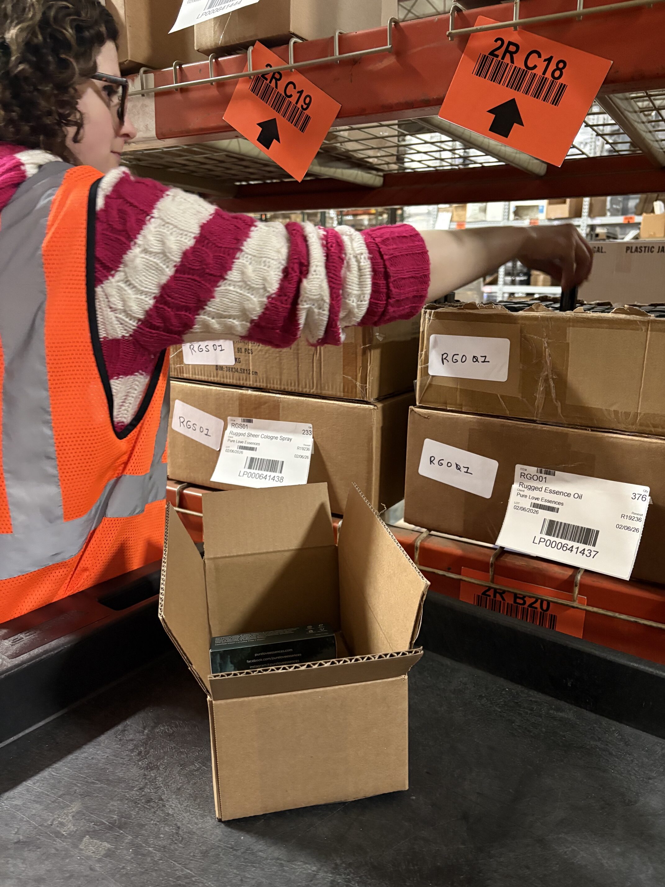 woman pulling inventory from warehouse shelf for shipment