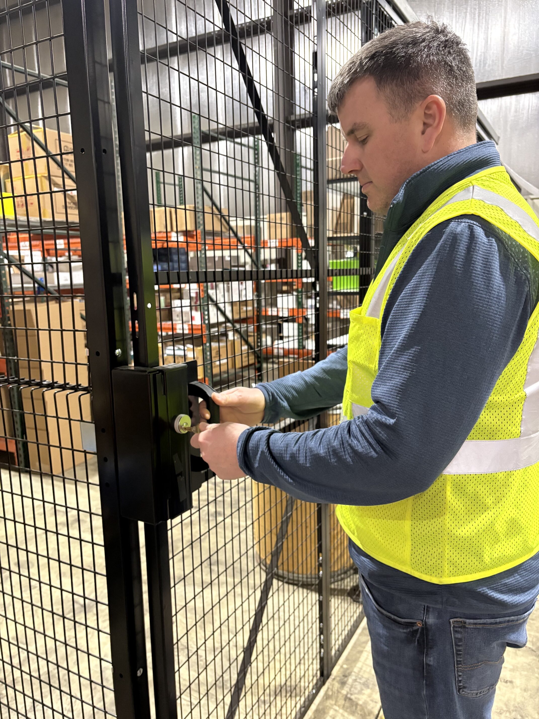 man opening a secure product area in warehouse