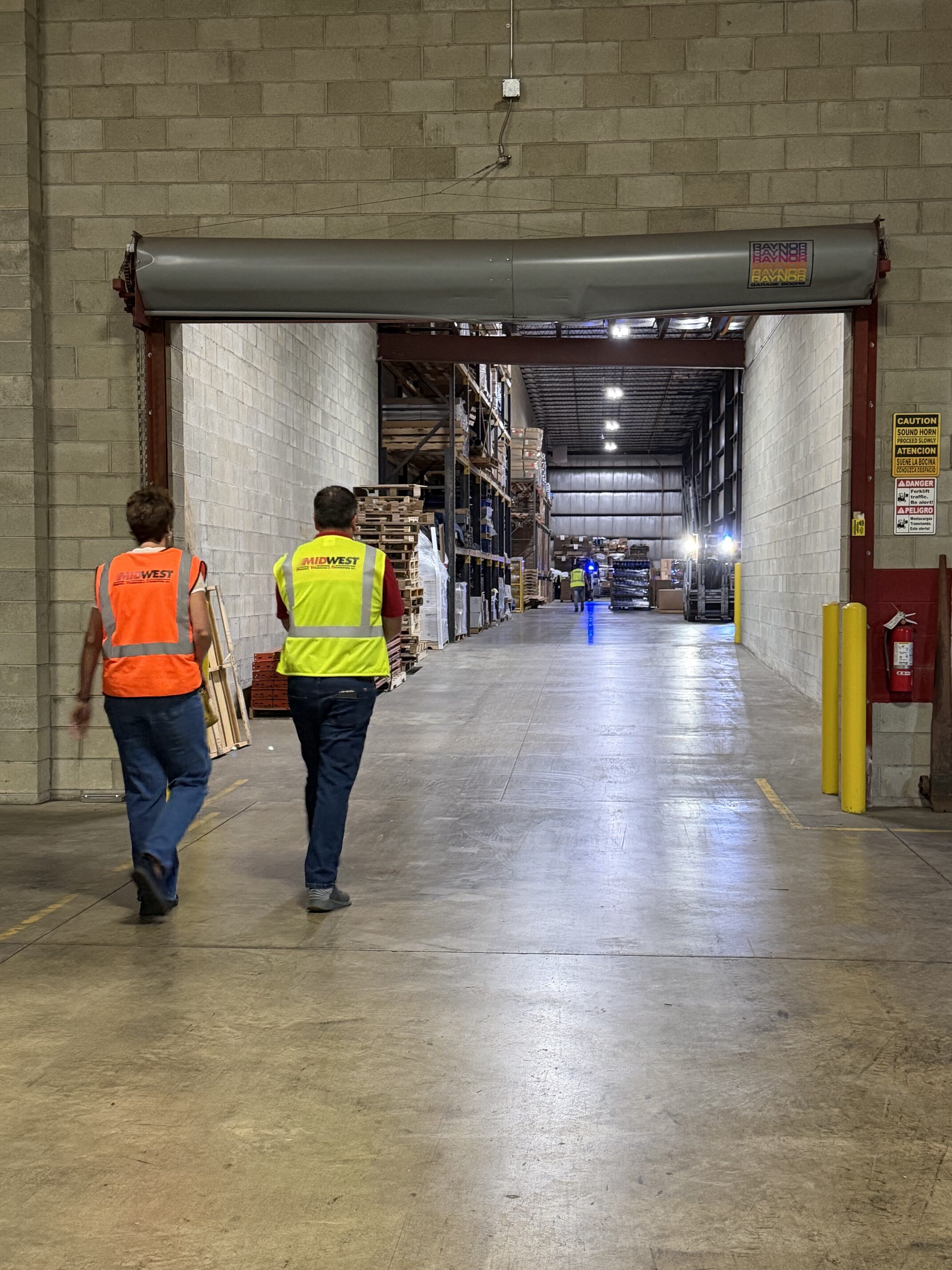 two people walking in warehouse